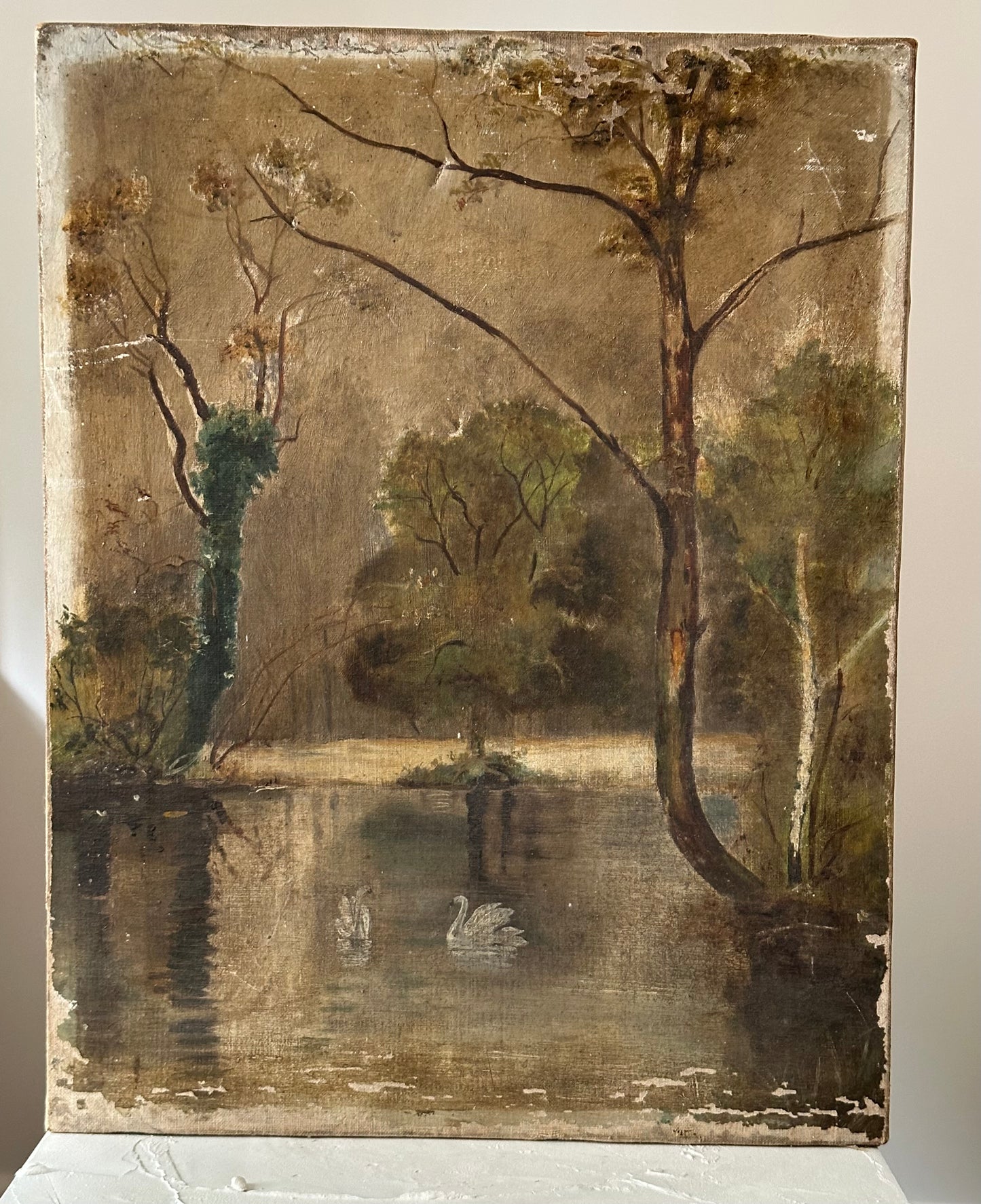 Vintage oil painting of swans on a lake with trees and water reflections